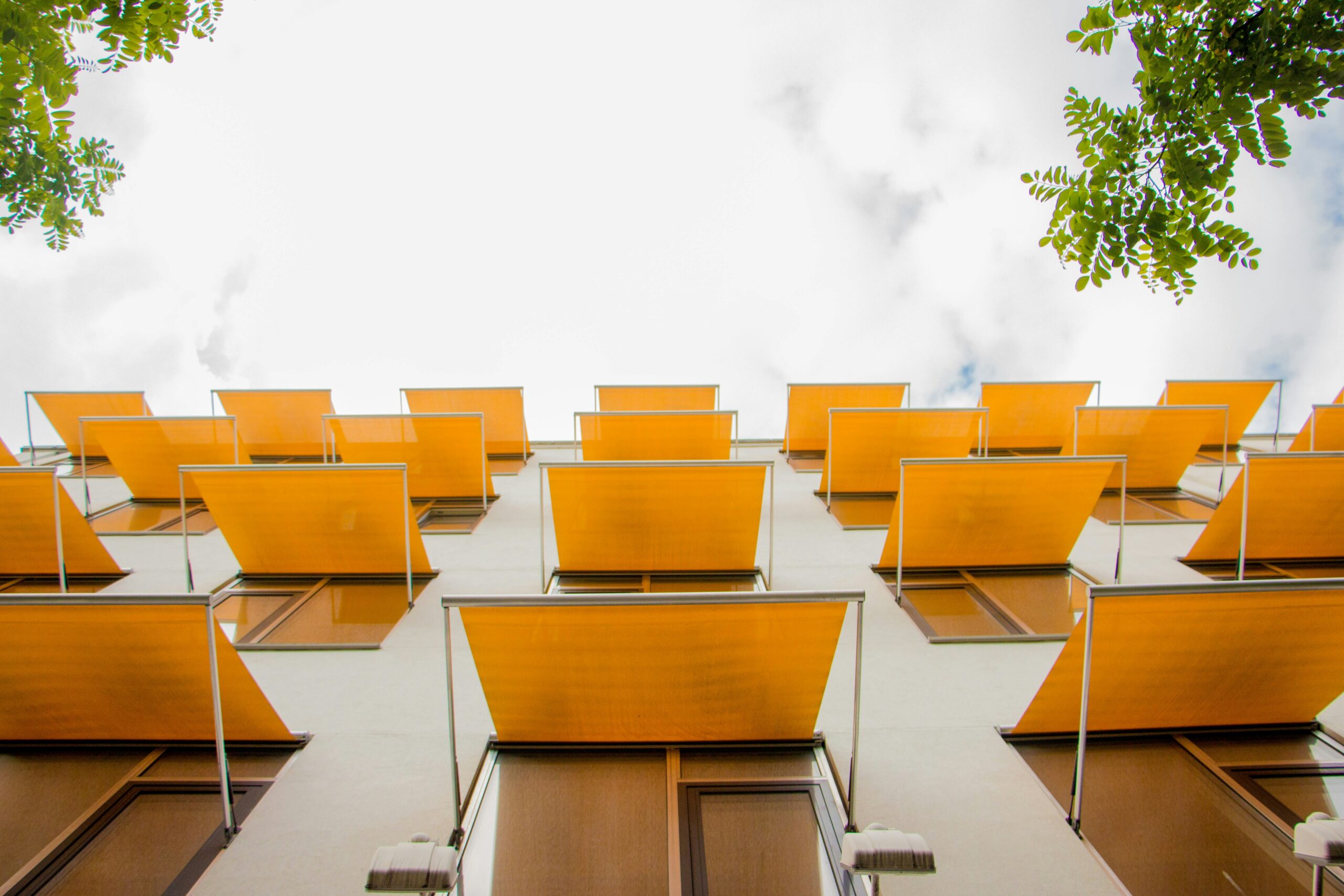 Aula moderna con sedie arancioni e struttura in metallo, vista dall'alto, ambiente luminoso con luce naturale